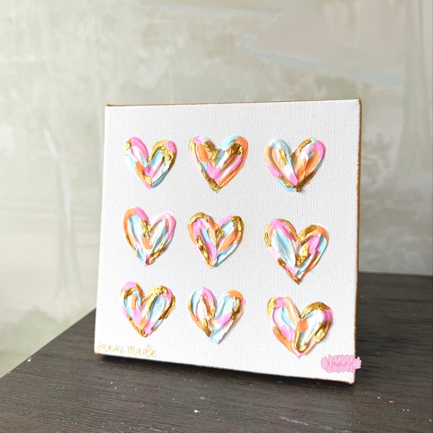 3-D painted pastel hearts in gold, soft blue, orange, and shades of pink on a 6x6 canvas.